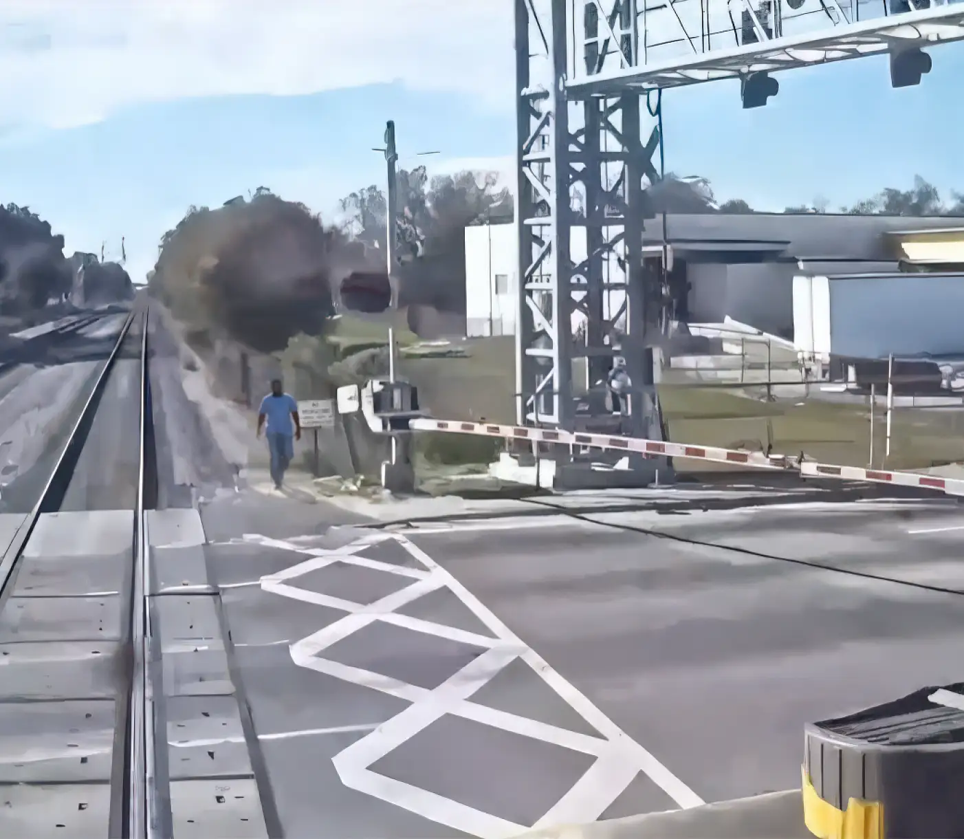 Image of pedestrian trespassing near train tracks.