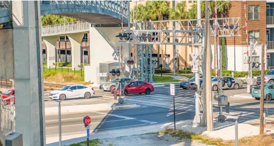 SunRail Get A Clue Photo 1 - Cars stopped on train tracks.